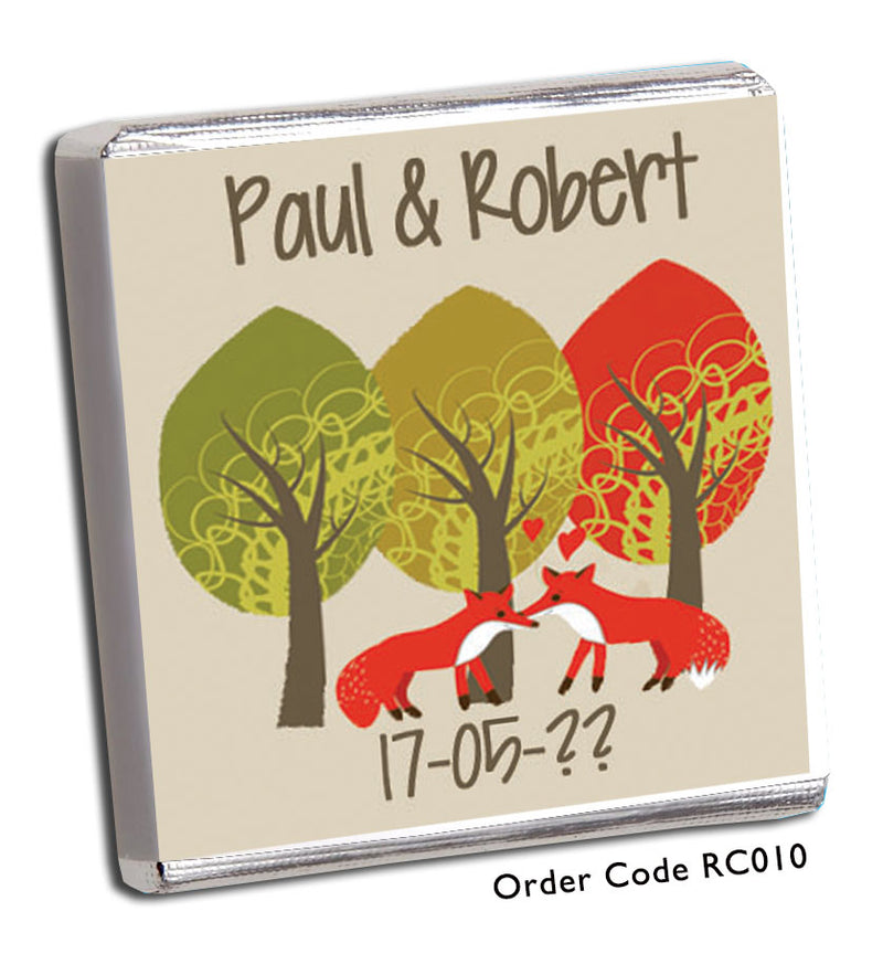 two foxes in front of three trees