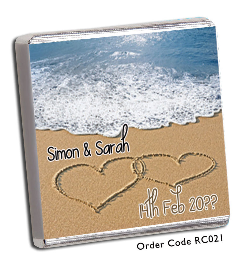 two hearts drawn in the sand on beach