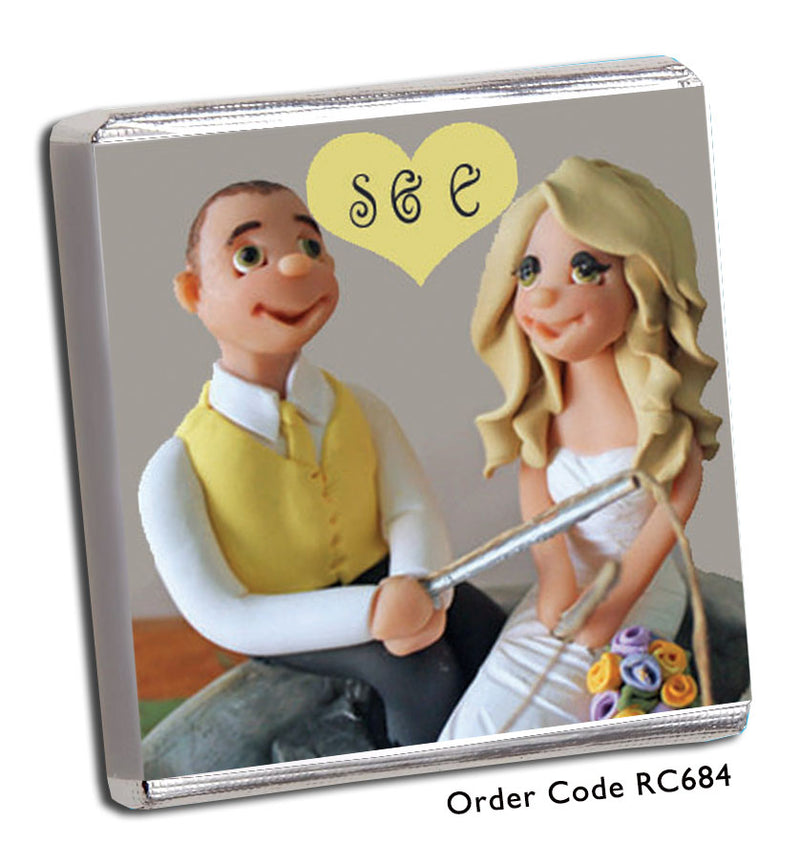 bride and groom holding a fishing rod wedding favour