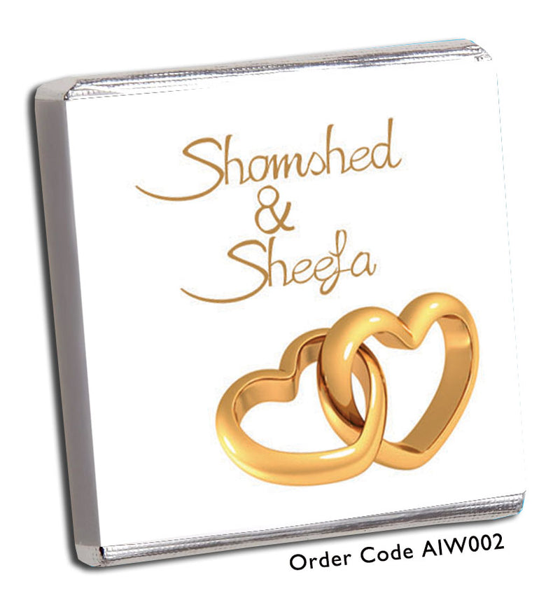 two gold hearts entwined on white background