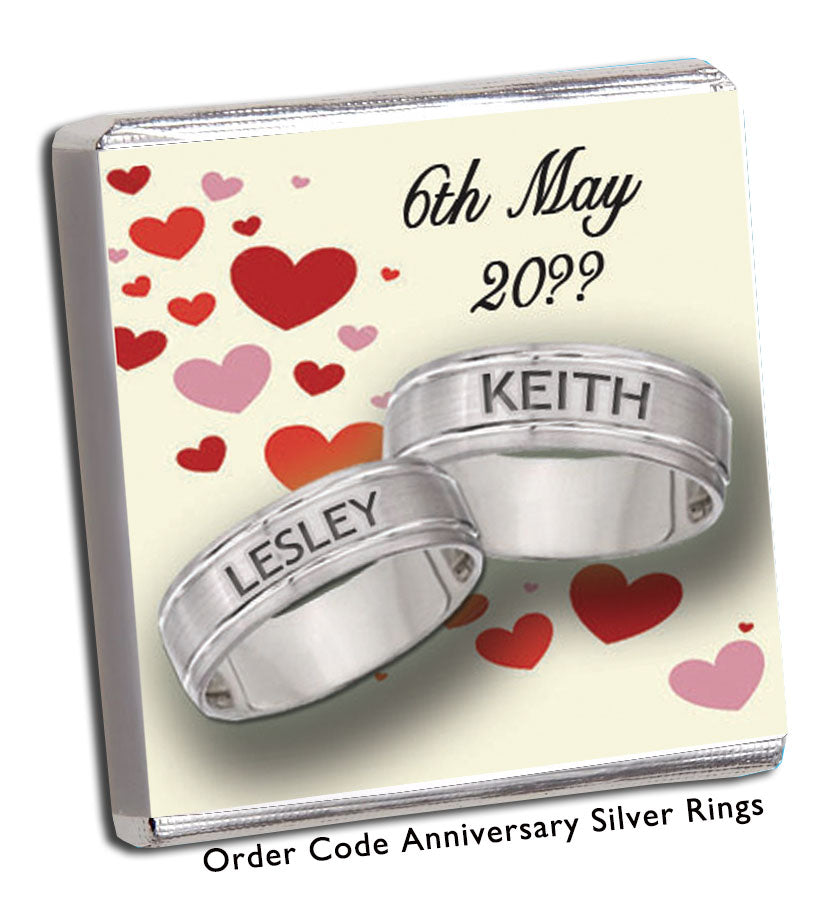 silver rings with red hearts in background