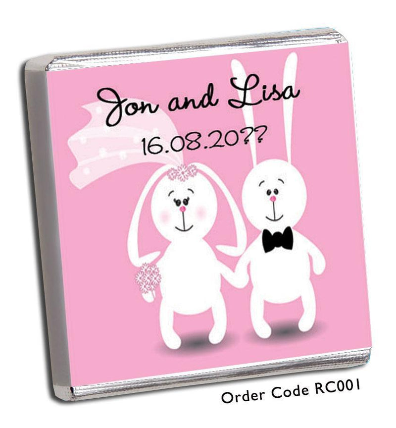 two cartoon bunnies holding hands on pink wedding favour