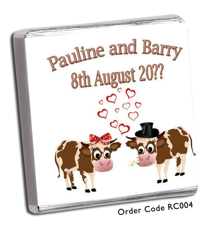 two brown cows in love on a wedding favour