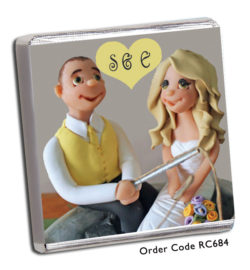 bride and groom holding a fishing rod wedding favour 